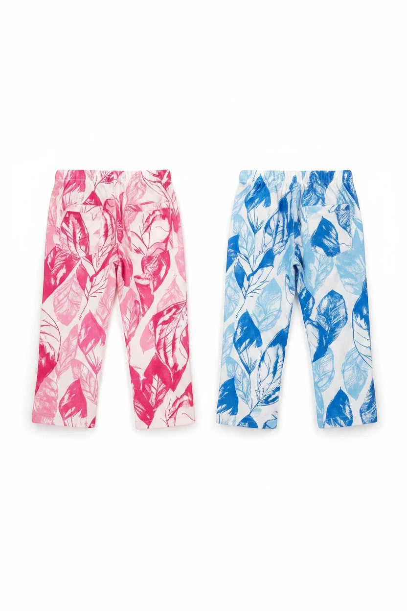 The Nile Luxuries girls' wide-leg trousers in pink and blue with artistic tropical leaf patterns and back pockets.