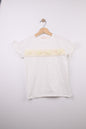 The Nile Luxuries white cotton t-shirt with ruffled sleeves, floral embellishments, and perforated stripes.