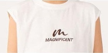 The Nile Luxuries white sleeveless t-shirt with "m MAGNIFICENT" graphic print.