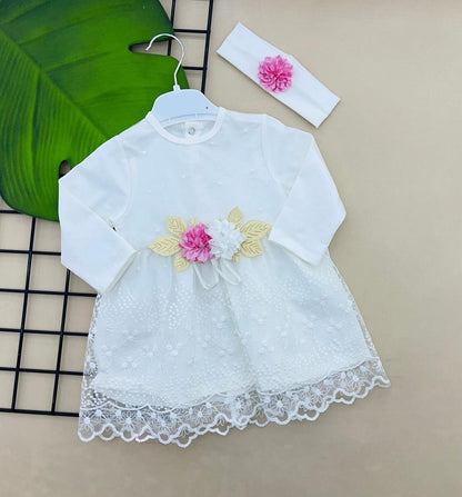 The Nile Luxuries white lace baby dress with pink and white floral applique and matching headband.
