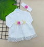 The Nile Luxuries white lace baby dress with pink and white floral applique and matching headband.