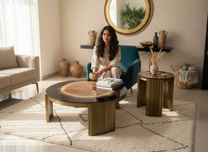 The Nile Luxuries rustic wood slice coffee table set with brass fluted pedestal bases and dark resin border.