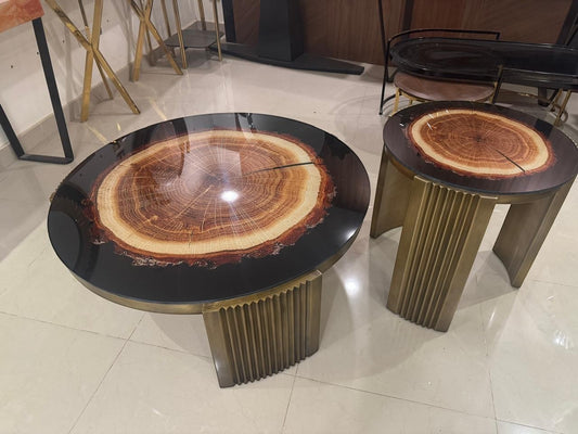 The Nile Luxuries rustic wood slice coffee table set with fluted brass pedestal bases and clear resin inlay.