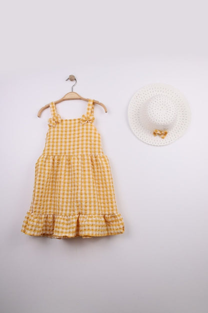 The Nile Luxuries yellow gingham ruffle dress with bow straps and matching hat. Lightweight fabric, perfect for summer.