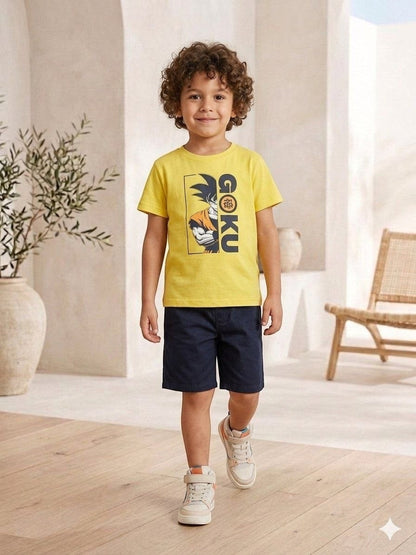 The Nile Luxuries yellow Dragon Ball Z Goku graphic t-shirt worn by a young boy with navy shorts and sneakers.