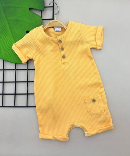 The Nile Luxuries yellow ribbed cotton baby romper with a three-button placket, cuffed sleeves, and a front pocket.