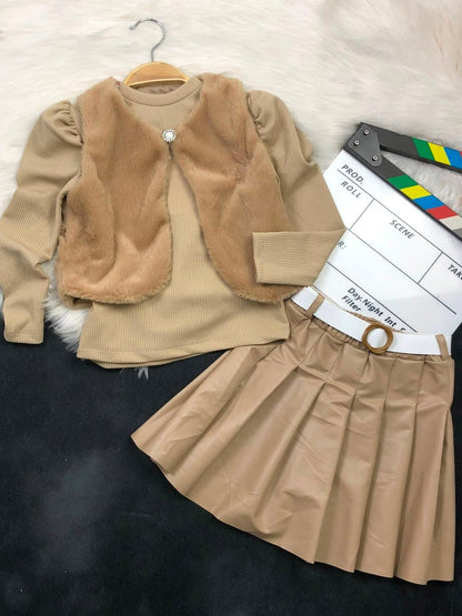 The Nile Luxuries three-piece youth outfit with a beige ribbed top, plush faux-fur vest, and pleated faux-leather skirt.