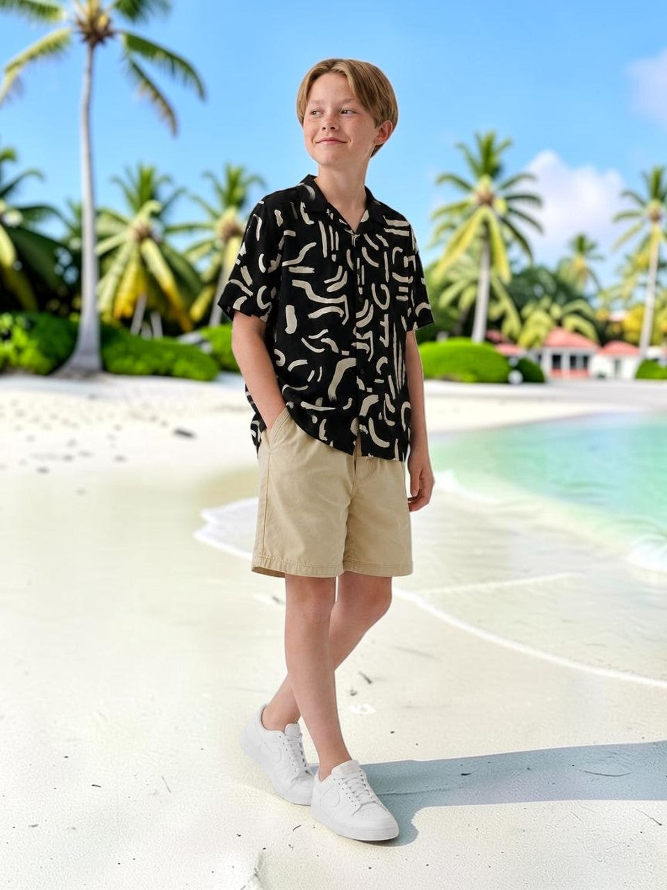 The Nile Luxuries black short-sleeve collared shirt with abstract print, worn by a boy.