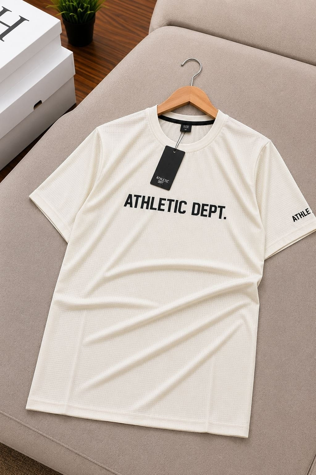 The Nile Luxuries off-white athletic dept. short sleeve t-shirt with crew neck and graphic text.
