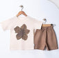 The Nile Luxuries cream t-shirt with brown flower graphic and brown shorts set for baby boys.