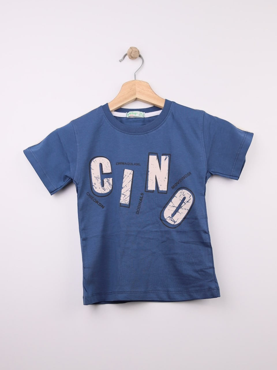 The Nile Luxuries blue cotton t-shirt for kids with a graphic print featuring large letters and abstract design.