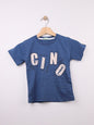 The Nile Luxuries blue cotton t-shirt for kids with a graphic print featuring large letters and abstract design.