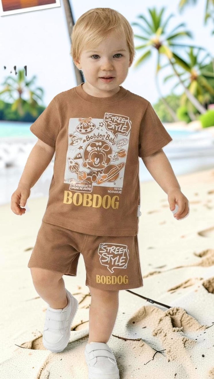 The Nile Luxuries Bobdog Baby brown cotton t-shirt and shorts set with cartoon graphic. Short sleeves, elastic waist.