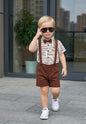 The Nile Luxuries boys brown shorts and white text print shirt set with suspenders and bow tie.