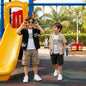 The Nile Luxuries boys' black and beige short-sleeve camp shirt and cargo shorts set with tropical graphic.