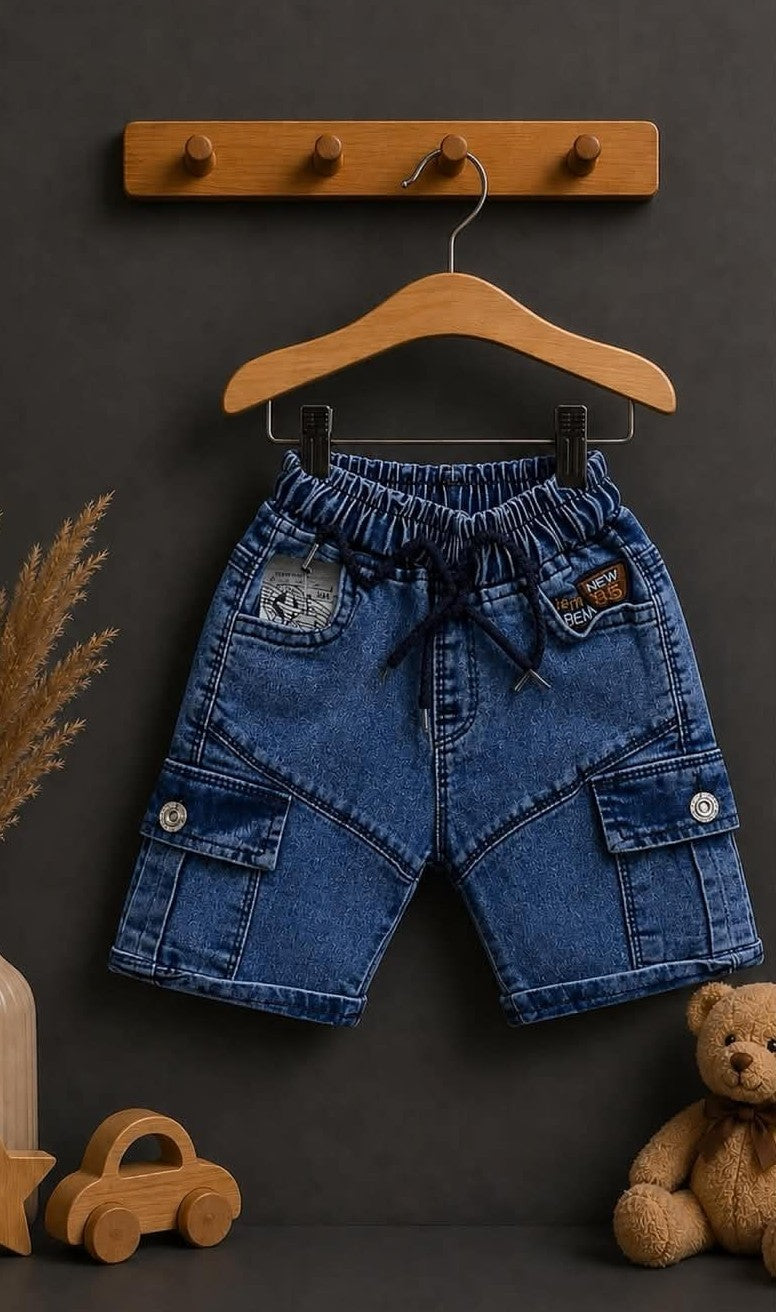 The Nile Luxuries boys blue denim cargo shorts with elastic waistband and drawstring. Features multiple pockets and patches.