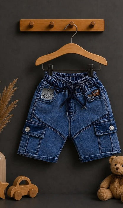 The Nile Luxuries boys blue denim cargo shorts with elastic waistband and drawstring. Features multiple pockets and patches.