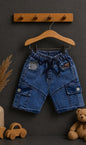 The Nile Luxuries boys blue denim cargo shorts with elastic waistband and drawstring. Features multiple pockets and patches.