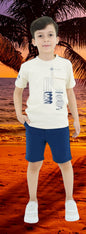 The Nile Luxuries cream cotton graphic print t-shirt with navy shorts set for boys. Features chest pocket and elastic waistband.