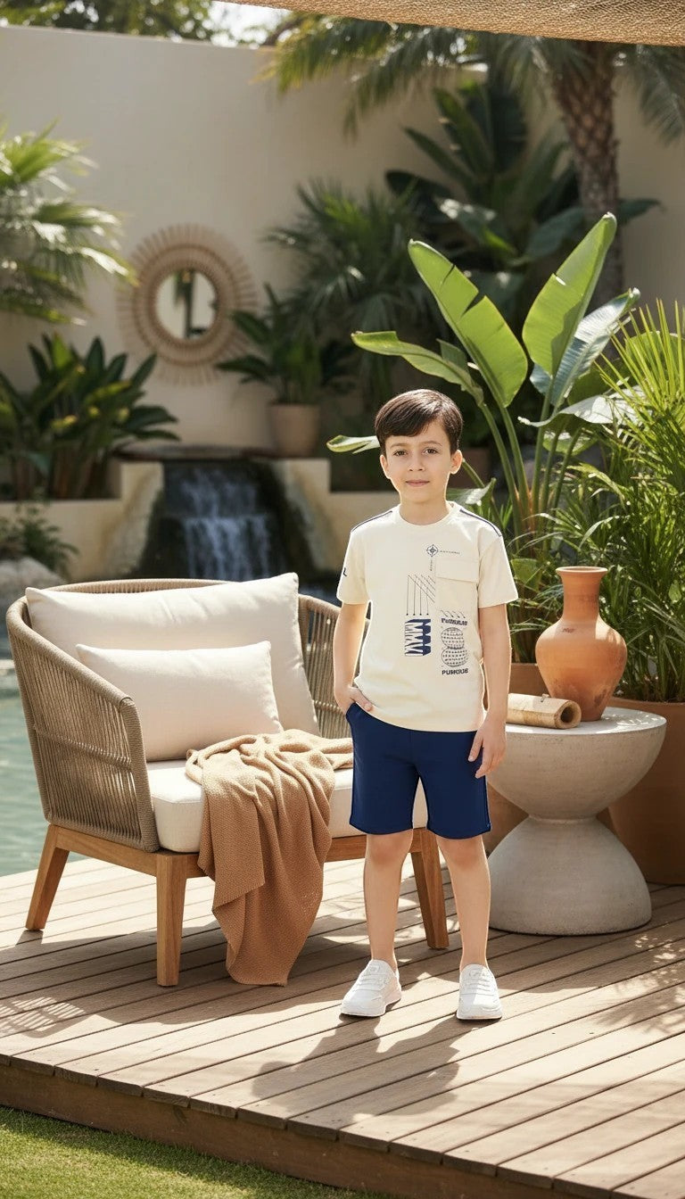 The Nile Luxuries boys' cream graphic print t-shirt with navy shorts set. Cotton tee has chest pocket & abstract design. Elastic waist shorts.