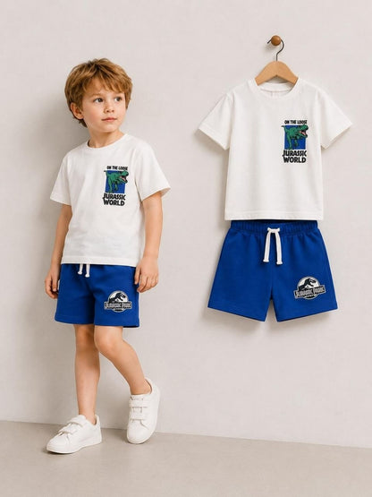 The Nile Luxuries boys' white Jurassic World t-shirt and blue shorts set. T-shirt features dinosaur graphic.