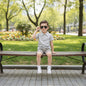 The Nile Luxuries boys' grey linen-blend polo shirt with brown and white striped shorts. Features a two-button placket and elastic waistband.