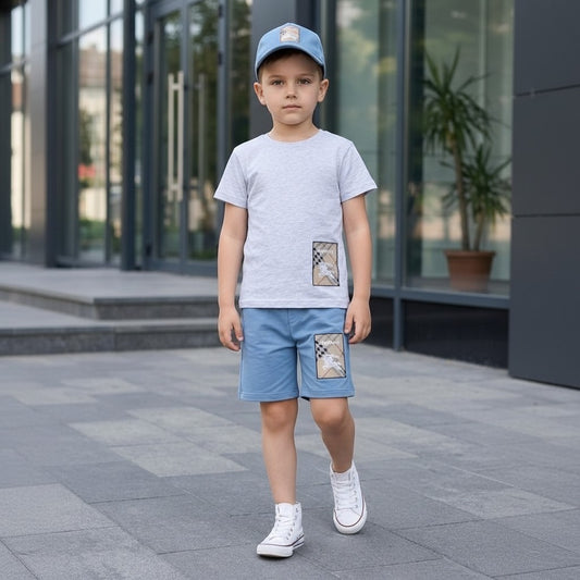 The Nile Luxuries boys' light grey t-shirt and dusty blue shorts set with checkered patch detail.