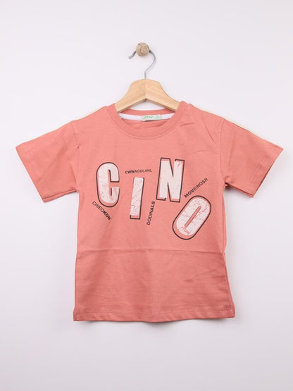 The Nile Luxuries coral cotton t-shirt for kids with abstract graphic print and stylized lettering.