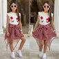 The Nile Luxuries girls' white sleeveless top with character graphic, paired with a red plaid handkerchief hem skirt and tie waist.