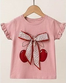 The Nile Luxuries girls dusty rose cotton t-shirt with cherry print and floral bow detail. Ruffled cap sleeves.