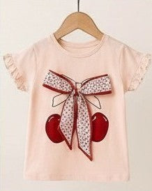 The Nile Luxuries girls peach cotton t-shirt with cherry graphic and floral bow, ruffled sleeves.
