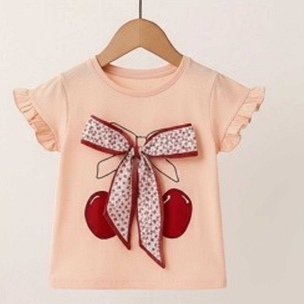 The Nile Luxuries girls peach cotton t-shirt with cherry print and floral bow, ruffled sleeves.