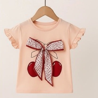 The Nile Luxuries girls peach cotton t-shirt with cherry print and floral bow, ruffled sleeves.