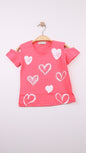 The Nile Luxuries girls' coral pink cotton t-shirt with cold shoulder cut and white heart prints.