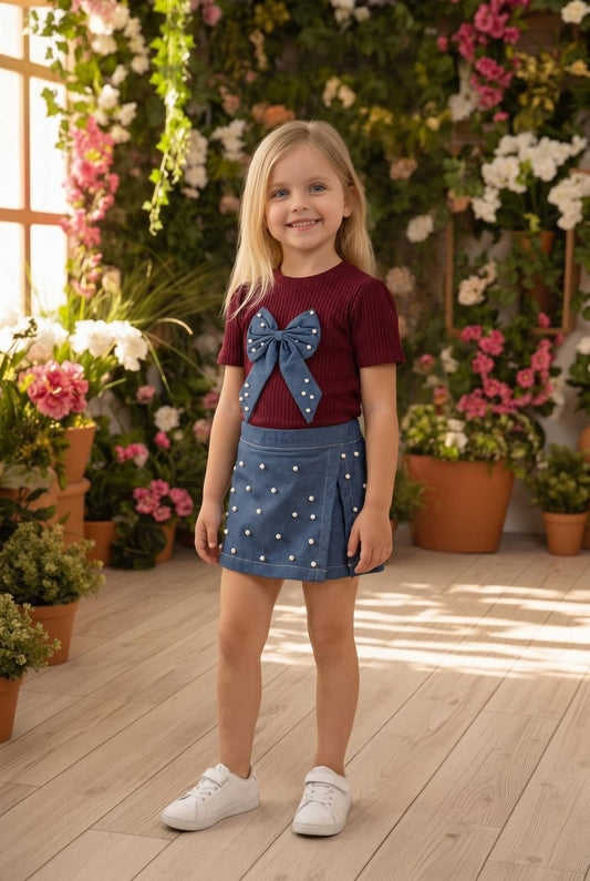 The Nile Luxuries girls blue denim skirt with pearl embellishments and pleats. A-line silhouette, adjustable waistband.