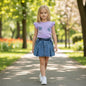 The Nile Luxuries Girls denim skirt and lavender graphic tee set with floral appliques and flutter sleeves.