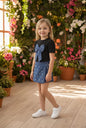 The Nile Luxuries girls blue denim skirt with pearl embellishments and A-line silhouette.