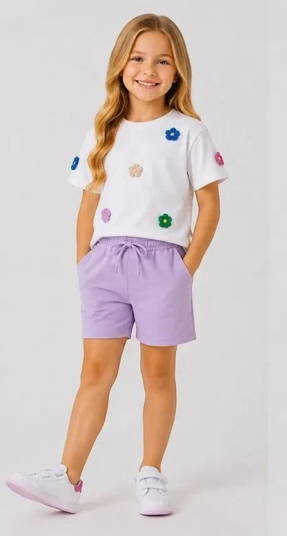 The Nile Luxuries Girls white cotton t-shirt with floral appliques and lavender jersey shorts with drawstring waist.