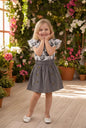 The Nile Luxuries girls' grey skirt with buttons and floral print top with ruffled sleeves.