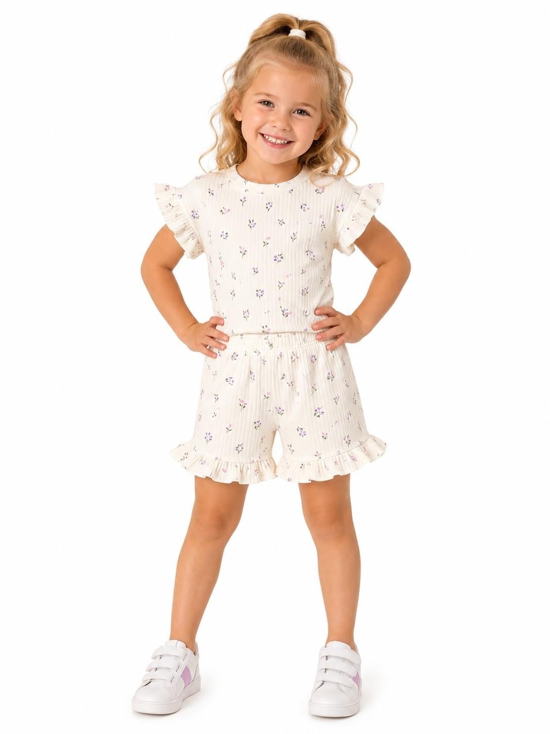 The Nile Luxuries girls' ivory ribbed knit floral print top with ruffled sleeves and matching shorts with ruffled hems.
