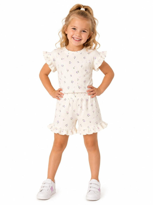 The Nile Luxuries girls' ivory ribbed knit floral print top with ruffled sleeves and matching shorts with ruffled hems.