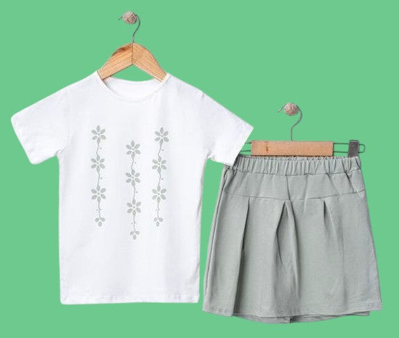 The Nile Luxuries girls' white t-shirt with floral print and light green pleated skirt set. Soft fabric.