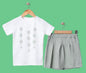 The Nile Luxuries girls' white t-shirt with floral print and light green pleated skirt set. Soft fabric.