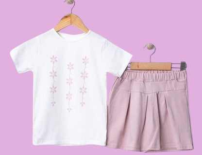 The Nile Luxuries girls' white t-shirt with pink floral print and pink pleated skirt set.