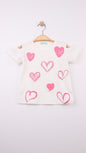 The Nile Luxuries girls' white cotton t-shirt with pink heart print and cold-shoulder design.
