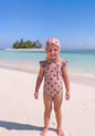 The Nile Luxuries girls' pink ribbed swimsuit with red hearts and matching bonnet, featuring ruffle sleeves.
