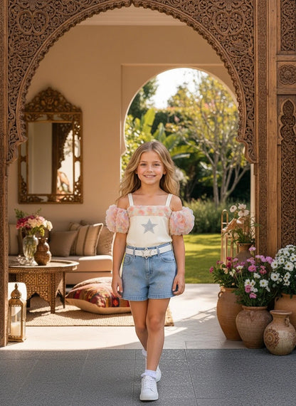 The Nile Luxuries girls' off-shoulder top with floral puff sleeves and star embellishment, paired with light-wash denim shorts with star details.