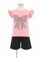 The Nile Luxuries girls pink t-shirt with leopard bow graphic and ruffled sleeves, paired with black shorts.