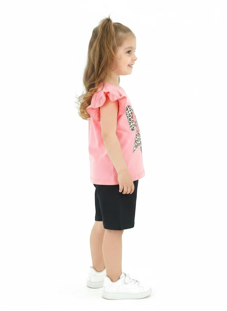 The Nile Luxuries pink t-shirt with leopard bow graphic and black shorts set for girls. Ruffled sleeves.