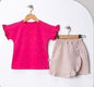The Nile Luxuries girls' bright pink cotton t-shirt with ruffled sleeves and a beige wrap skirt with ruffled trim.